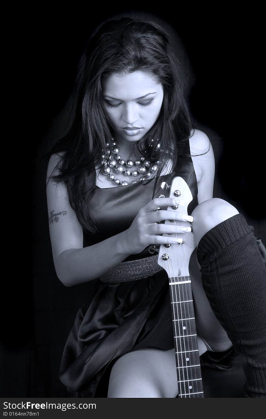 Black & white image of female rocker with her guitar. Black & white image of female rocker with her guitar