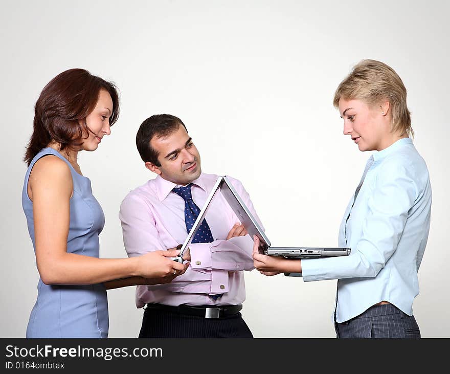 Three colleagues working at a computer