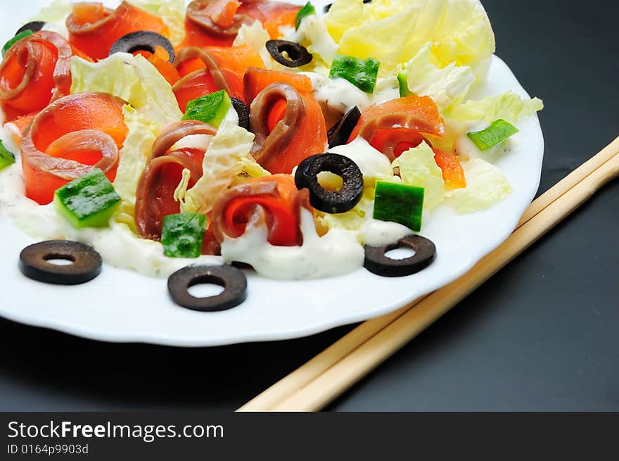 Salmon salad on white plate