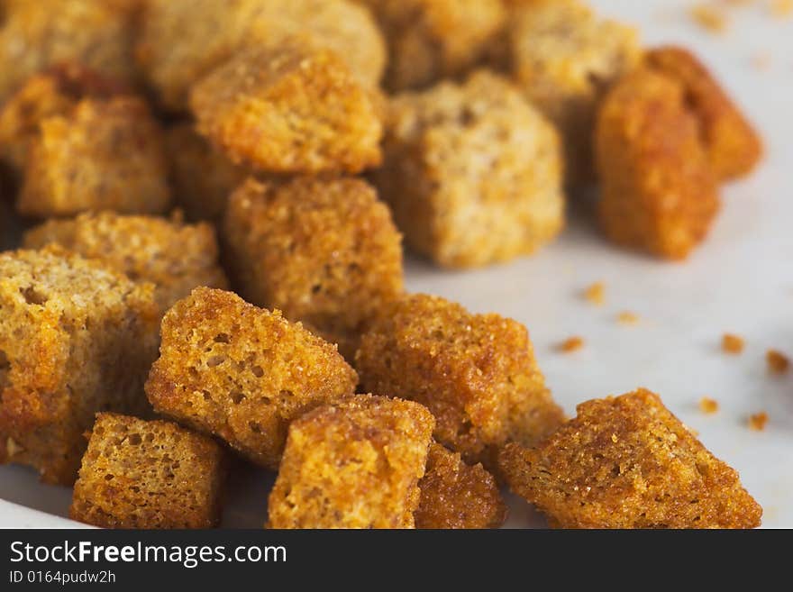 Encrusted dried bread bits snack on the plate. Encrusted dried bread bits snack on the plate