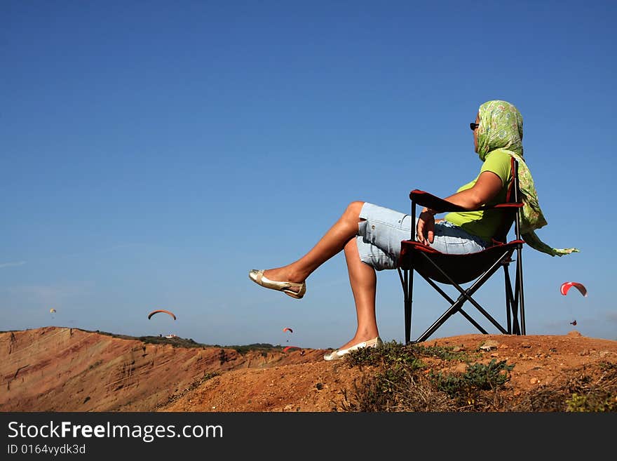 A person seated on a chair. A person seated on a chair