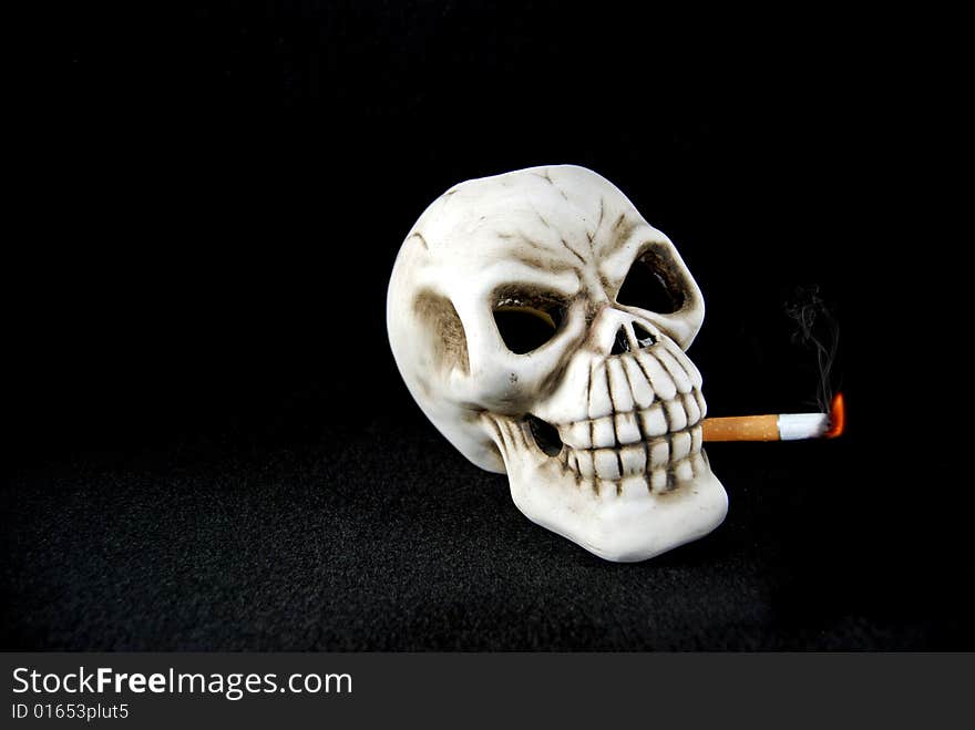 Smoking skull with burning cigarette. Smoking skull with burning cigarette.