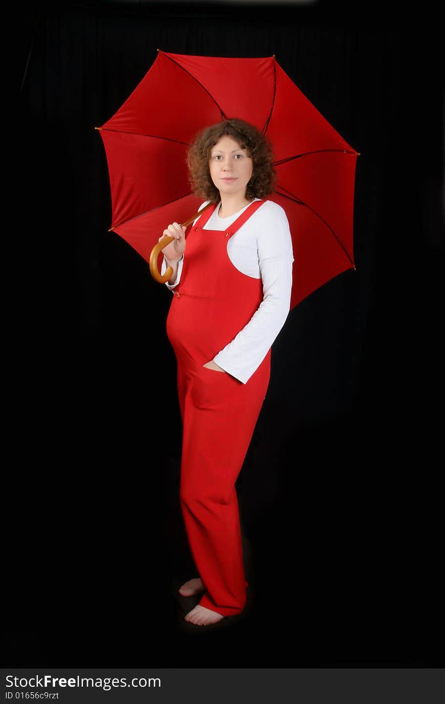 Young pregnant with red umbrella