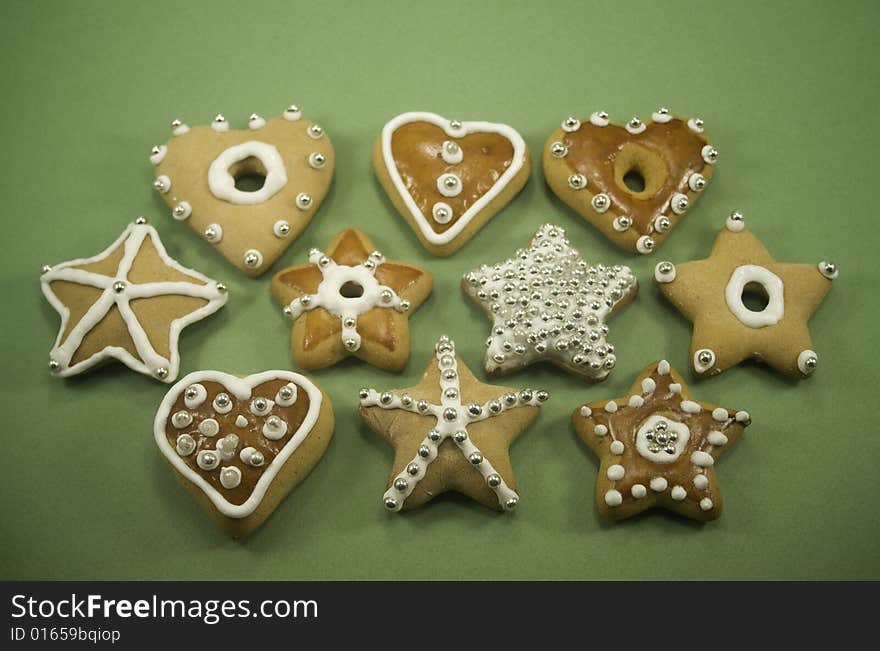 Decorated star and heart cookies on green paper. Decorated star and heart cookies on green paper