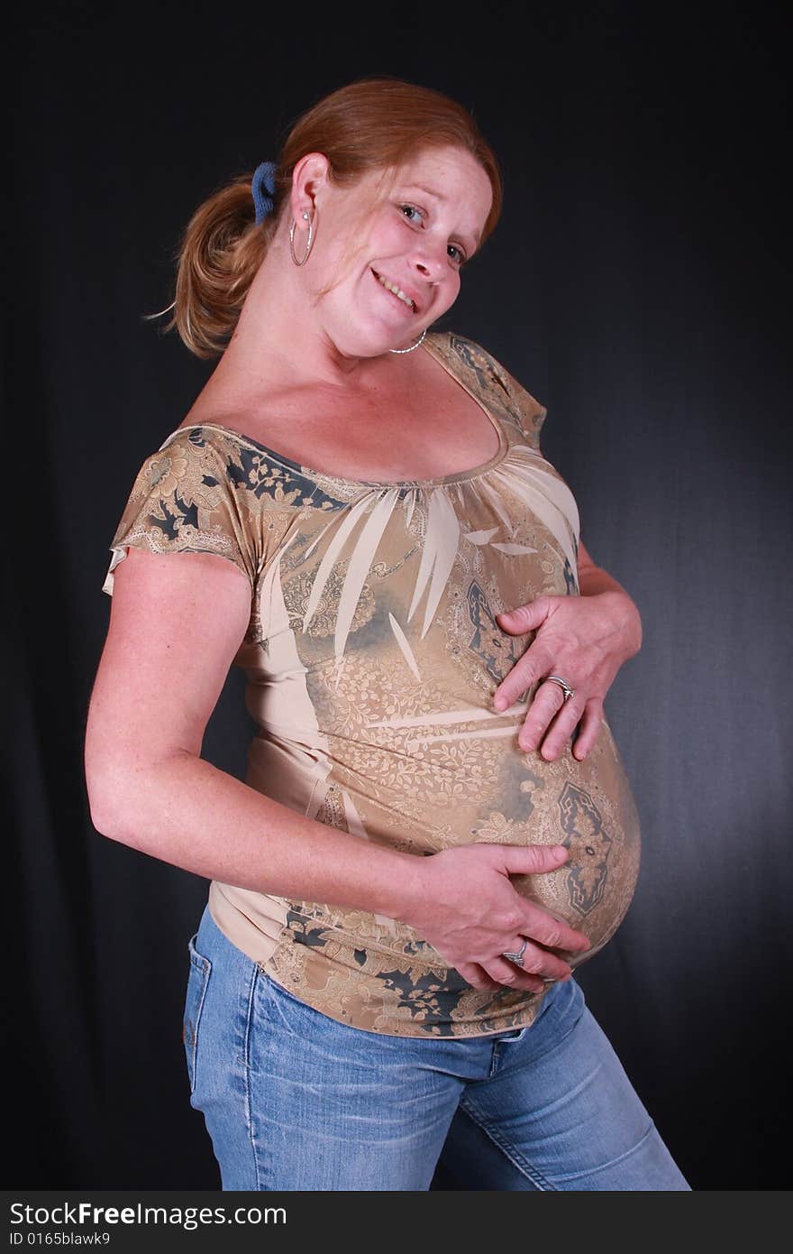 Very happy mommy with her hands on her pregant belly. Very happy mommy with her hands on her pregant belly