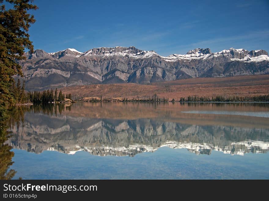 The Canadian Rocky Mountains reflected in Talbot Lake near Jasper, Alberta, Canada. The Canadian Rocky Mountains reflected in Talbot Lake near Jasper, Alberta, Canada.