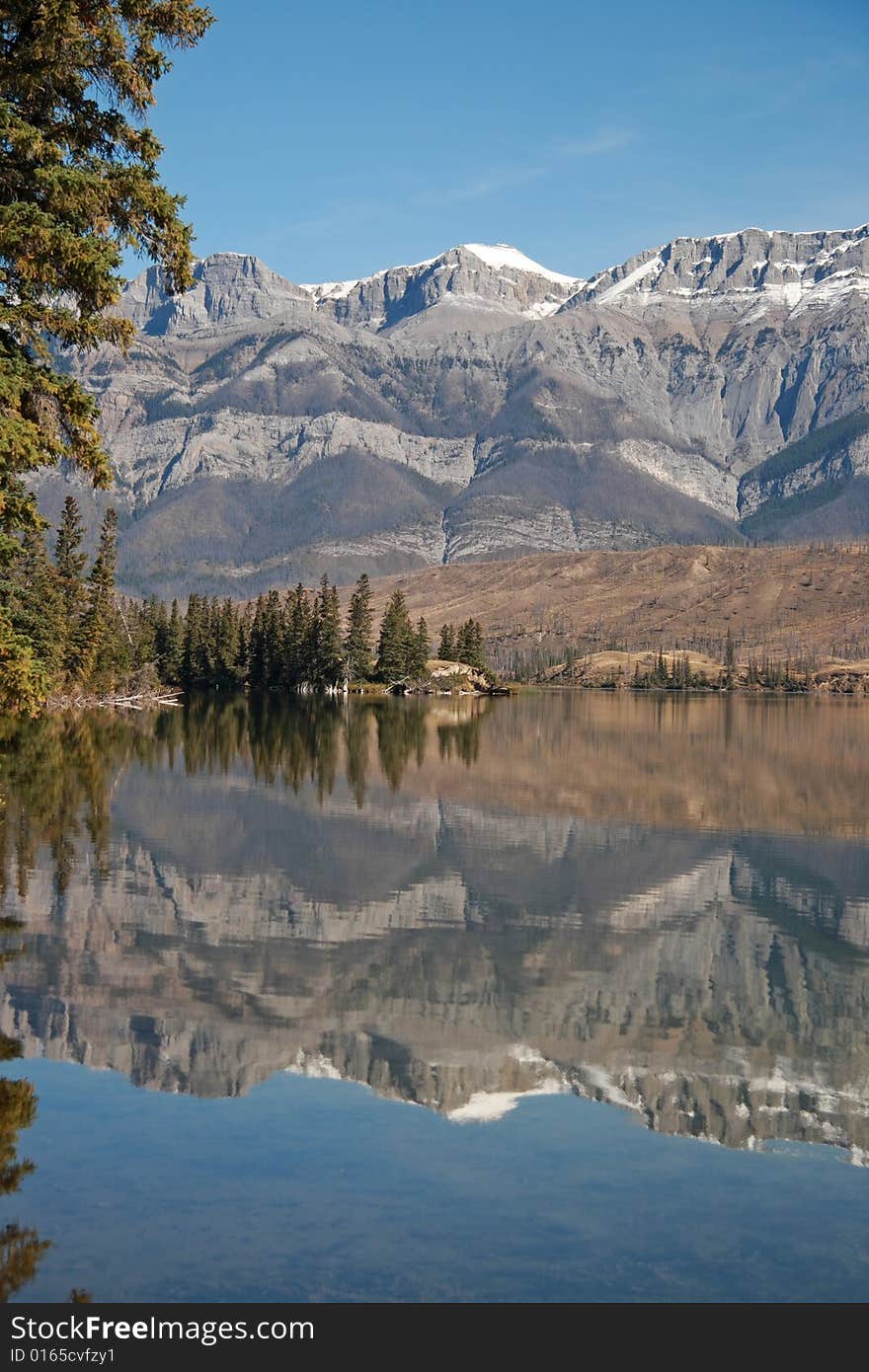 The Canadian Rocky Mountains reflected in Talbot Lake near Jasper, Alberta, Canada. The Canadian Rocky Mountains reflected in Talbot Lake near Jasper, Alberta, Canada.