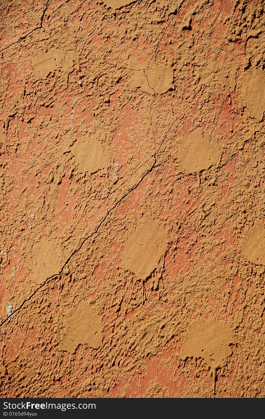 Detail of the pattern on an orange stucco wall. Detail of the pattern on an orange stucco wall