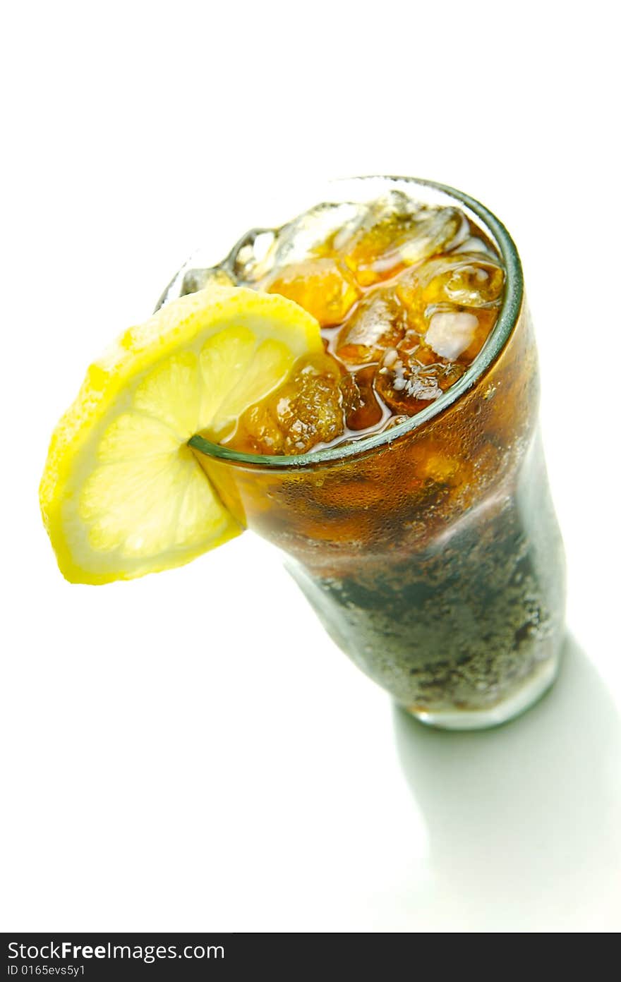 A glass of lemon cola isolated against a white background