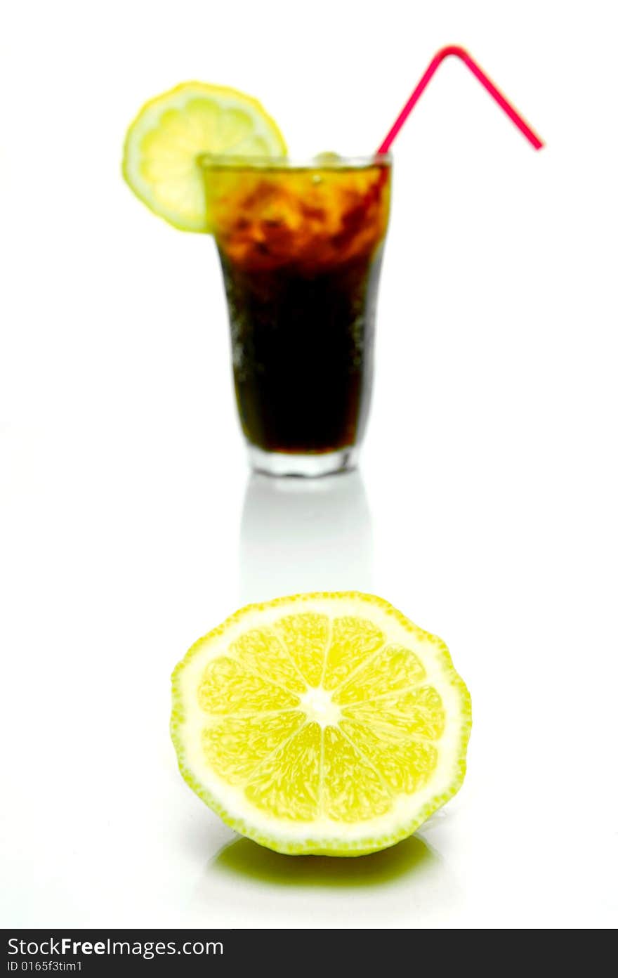 A glass of lemon cola isolated against a white background