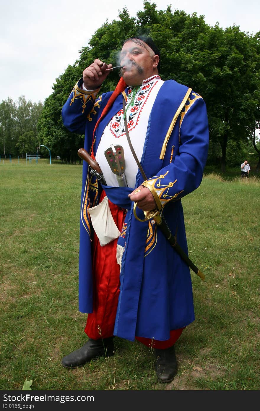 Old ukrainian Cossack with long whiskers smoking pipe. Old ukrainian Cossack with long whiskers smoking pipe