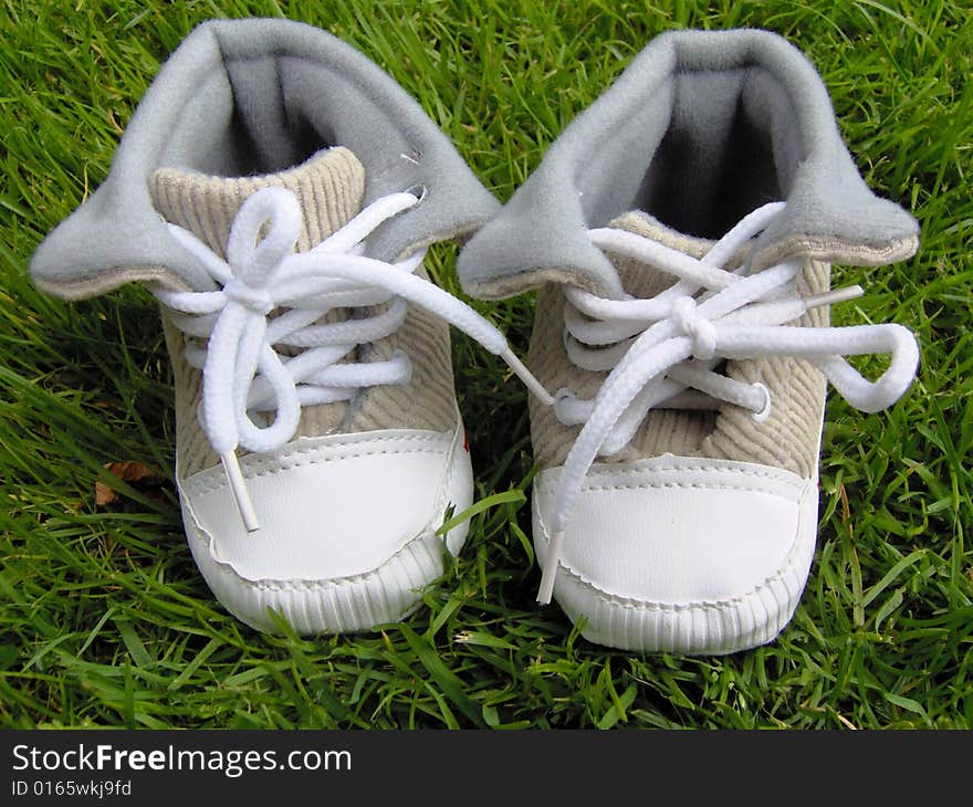 cute baby shoes on the grass in the garden