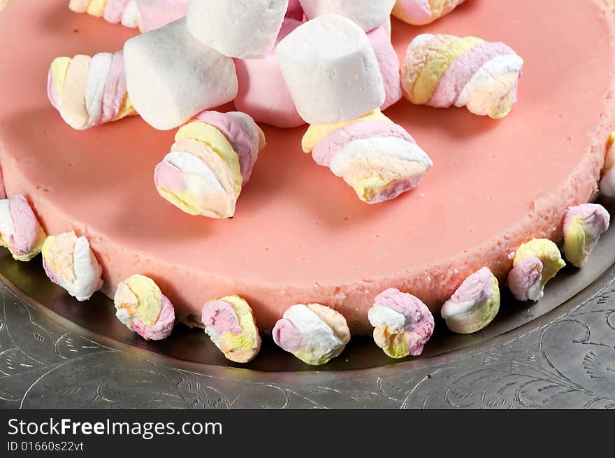 Marshmallow cheese cake on a silver platter.  The cake is made from cream cheese, marsh mellows, digestive biscuits (cookies), butter and cream.