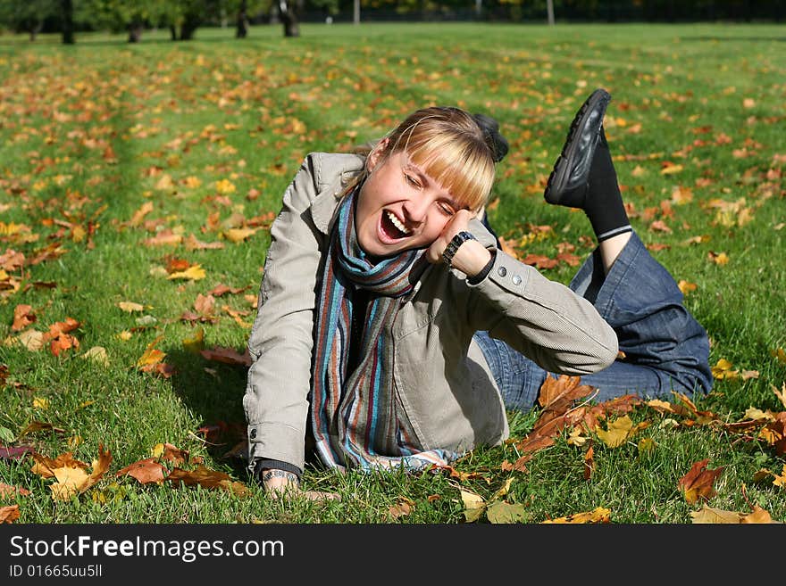 Beautiful blond young woman in autumn park