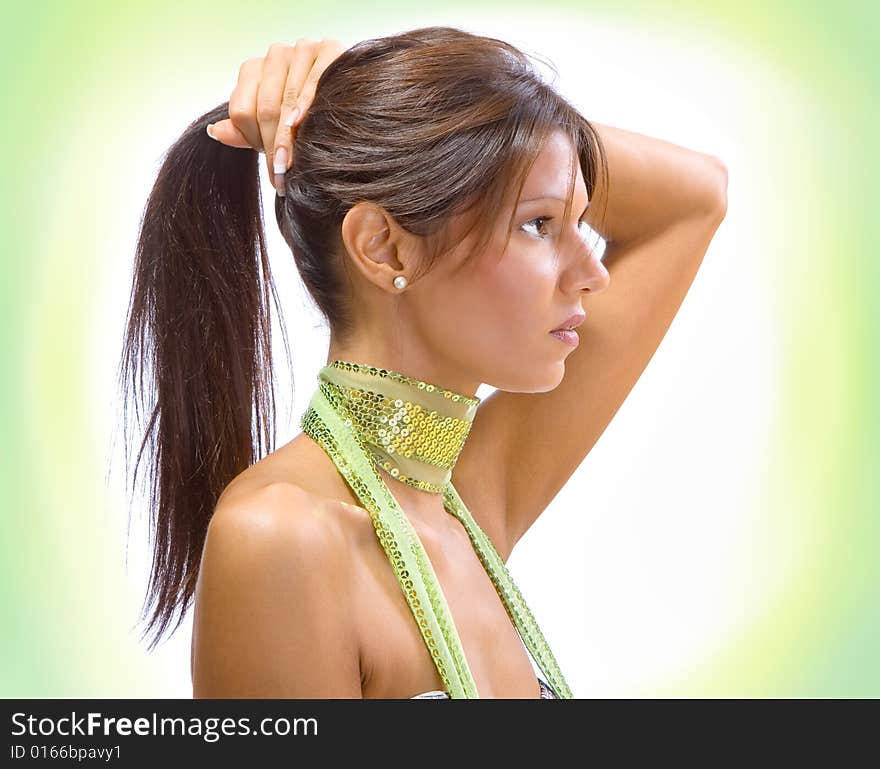 Beautiful brunette posing, isolated on mottled yellow and green background