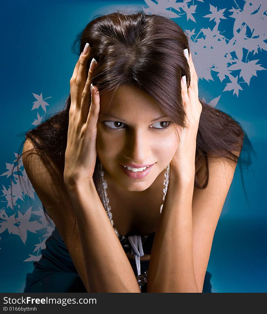 Beautiful brunette posing, isolated on mottled  background