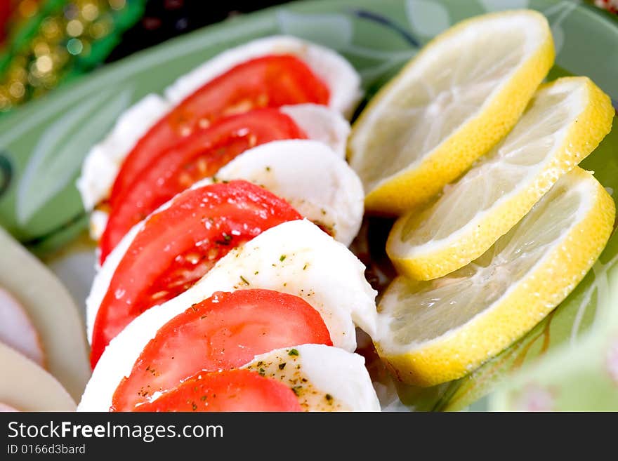 Tasty tomato mozzarella salad dish and some salad dressing. Tasty tomato mozzarella salad dish and some salad dressing