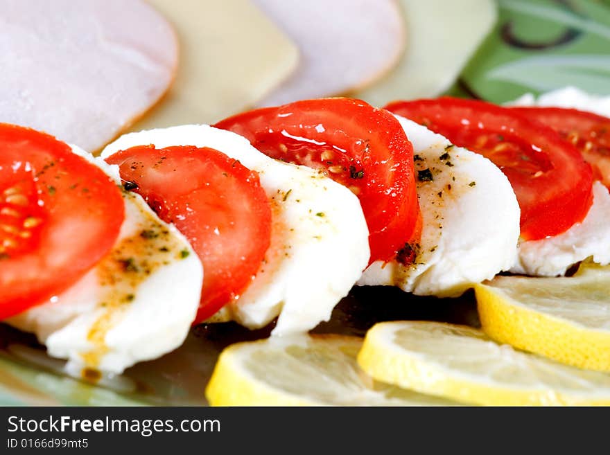 Tasty tomato mozzarella salad dish and some salad dressing. Tasty tomato mozzarella salad dish and some salad dressing