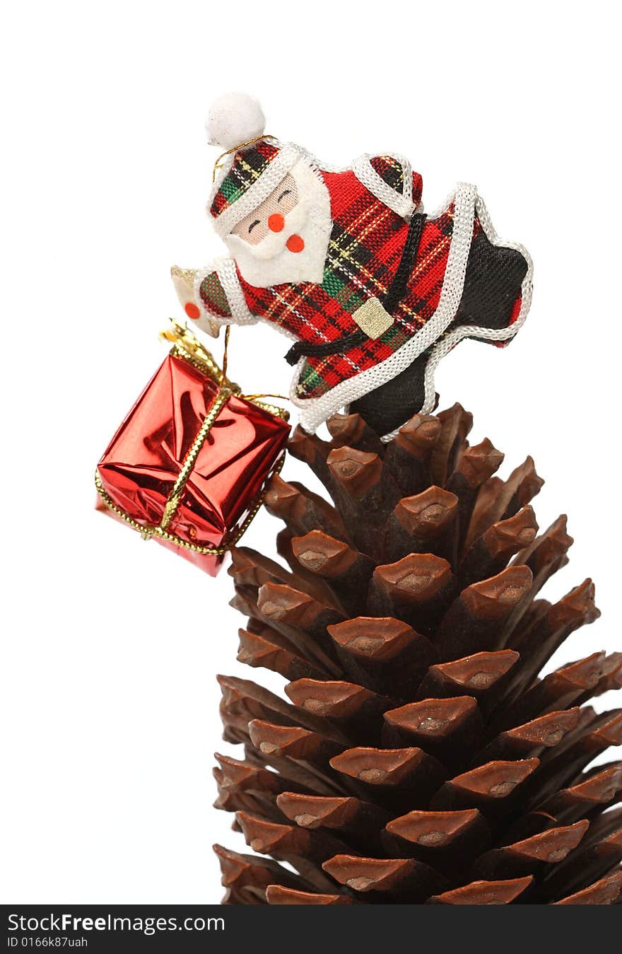 Christmas santa with gift box over a pine cone