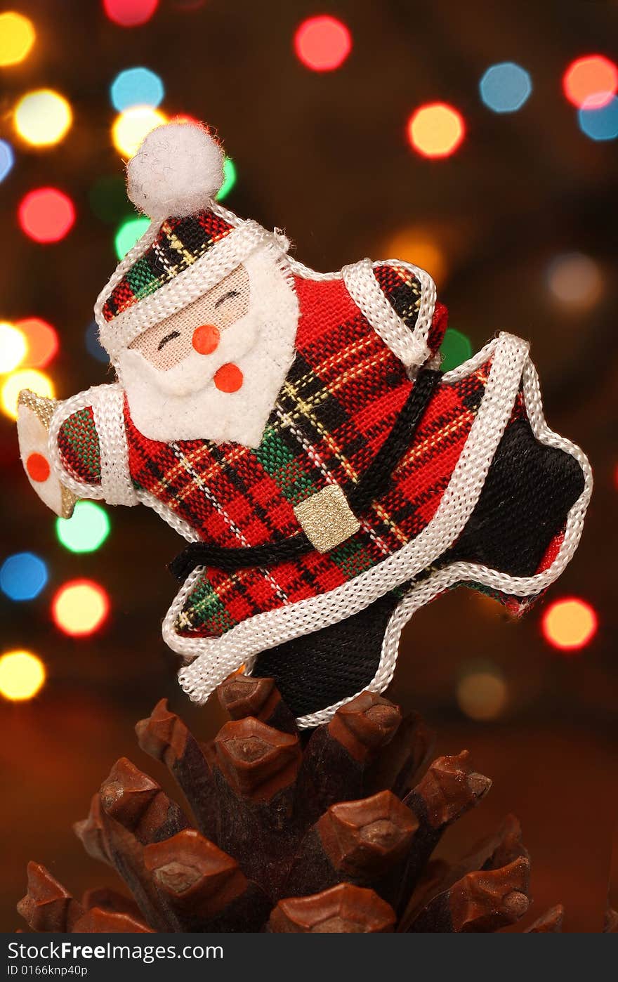 Santa with gift box over a pine cone