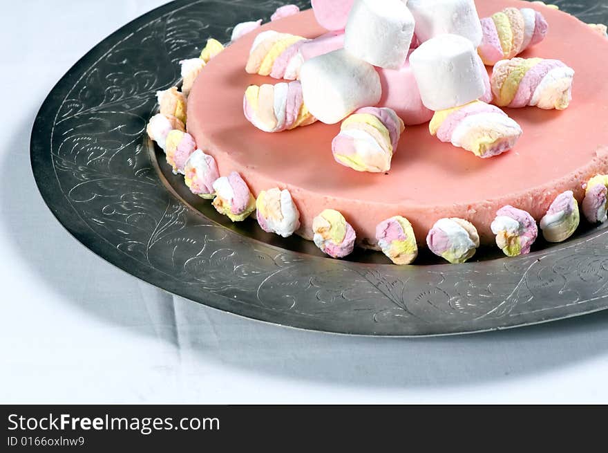 Marshmallow cheese cake on a silver platter.  The cake is made from cream cheese, marsh mellows, digestive biscuits (cookies), butter and cream.