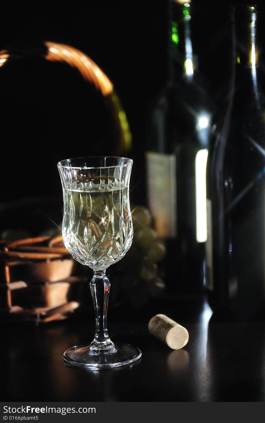 An image of crystal wine glasses filled with white wine