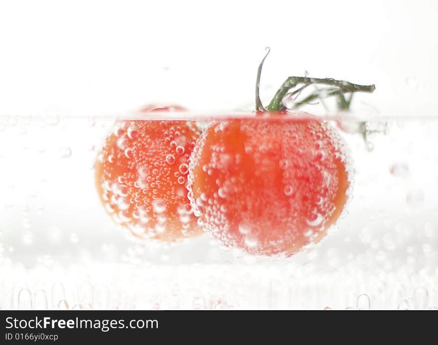 Fresh tomatoes in sparkiling water. Fresh tomatoes in sparkiling water