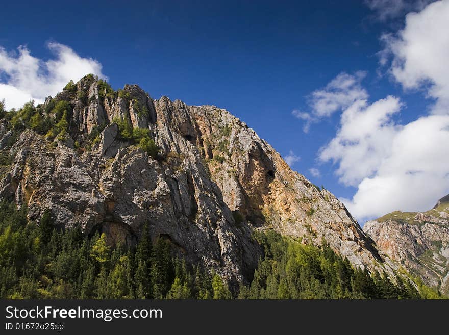 The steep mountains and the blue sky. The steep mountains and the blue sky