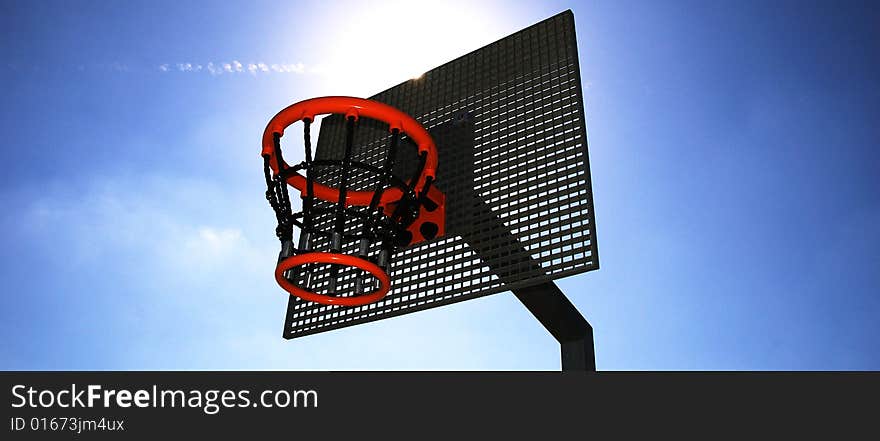 Basketball hoop and backboard set against a blue sky. Basketball hoop and backboard set against a blue sky