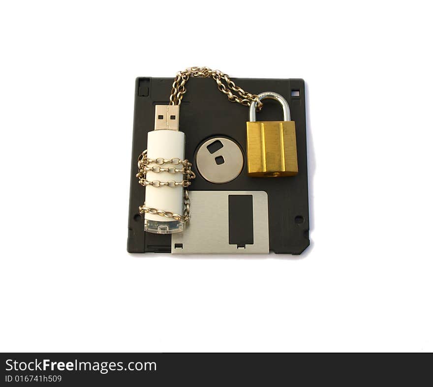 Photograph of a computer data stick, wrapped with silver chain and padlocked with gold padlock, lying on a floppy disk. Isolated white background. Photograph of a computer data stick, wrapped with silver chain and padlocked with gold padlock, lying on a floppy disk. Isolated white background.