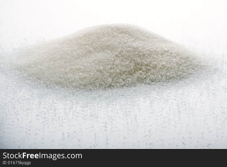 The big heap of sugar on a white background