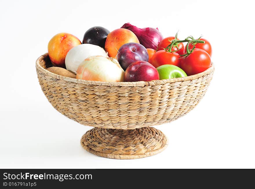 Pedestal basket full of autumn fruits and vegetables. Pedestal basket full of autumn fruits and vegetables