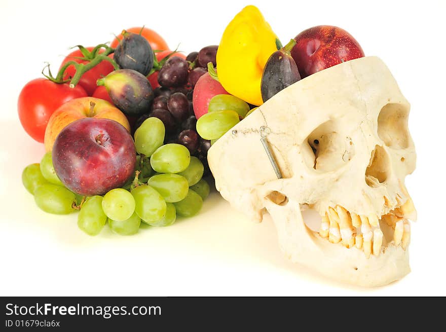 A human skull overflowing with fruits and vegetables, like a horn of plenty. A human skull overflowing with fruits and vegetables, like a horn of plenty.