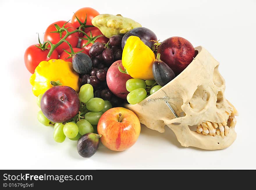 A human skull overflowing with fruits and vegetables, from above. A human skull overflowing with fruits and vegetables, from above.