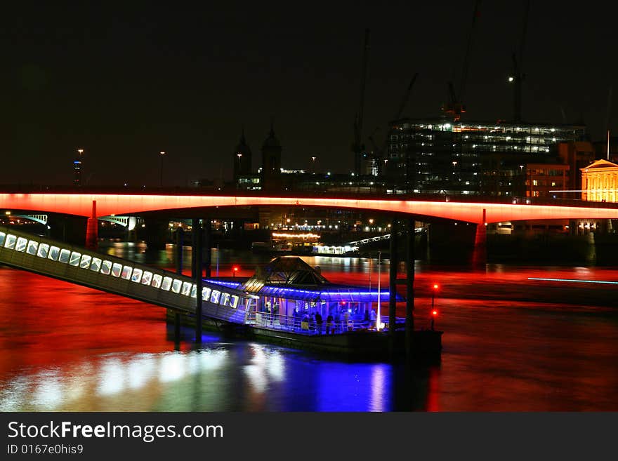 A colourful photo of London bridge at night