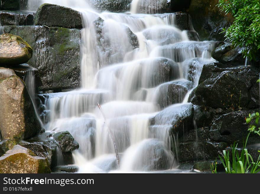 A water fall in a park at valley gardens in London UK. A water fall in a park at valley gardens in London UK