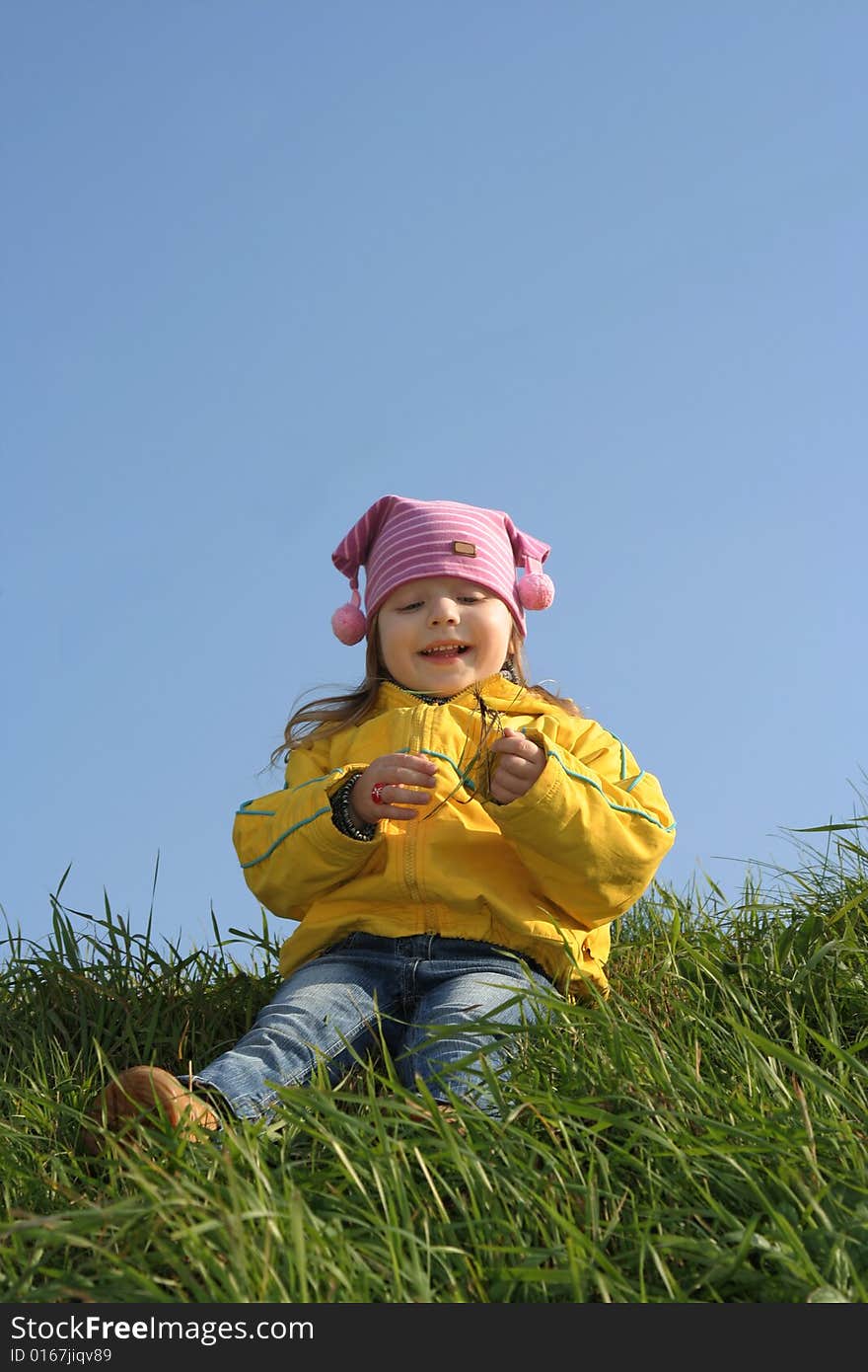 Smiling Girl Sits On A Hill