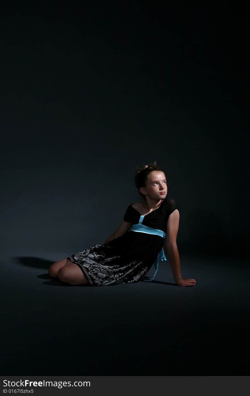 Pretty Girl In Black Dress Sitting On Floor