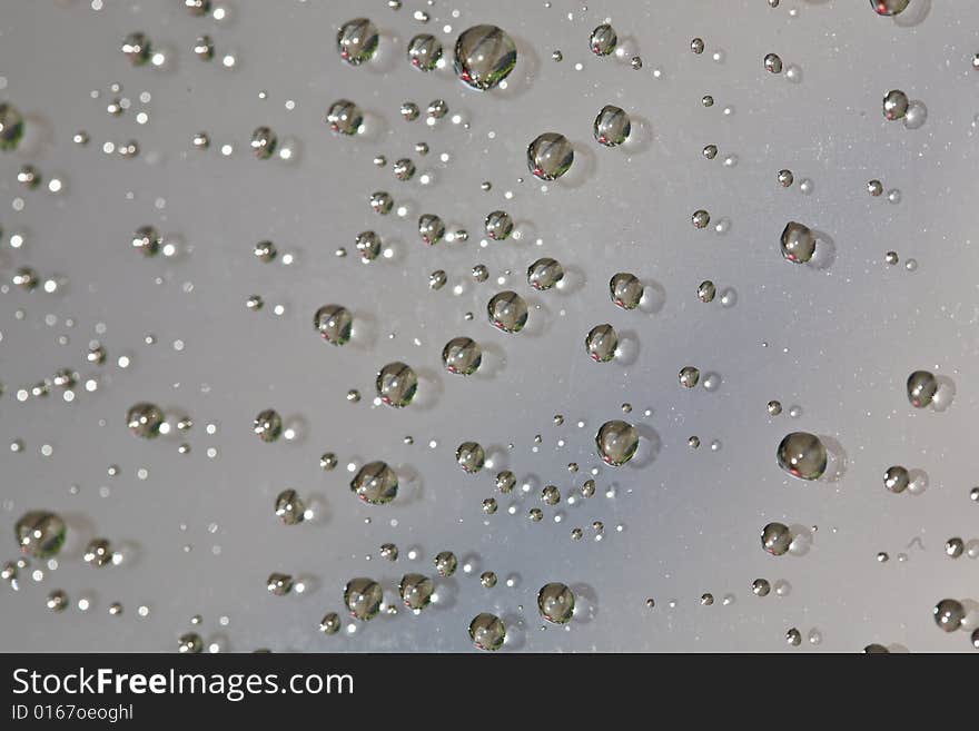 Rain drops on glass surface closeup