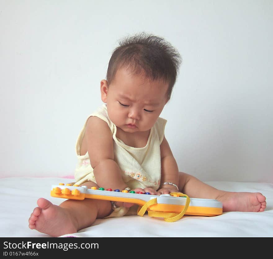 Lovely baby and toy guitar