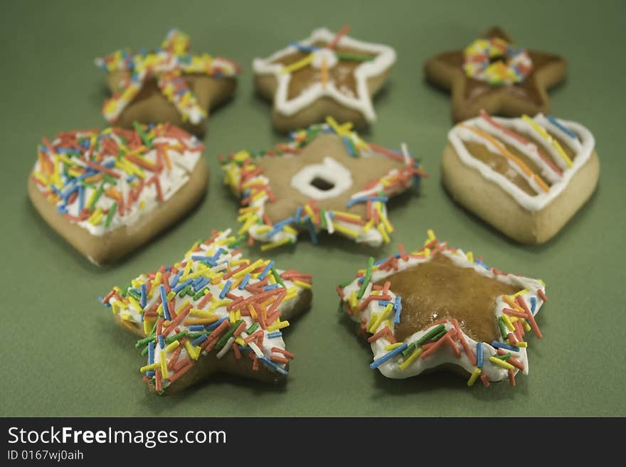 Decorated gingerbread cookies on green paper. Decorated gingerbread cookies on green paper