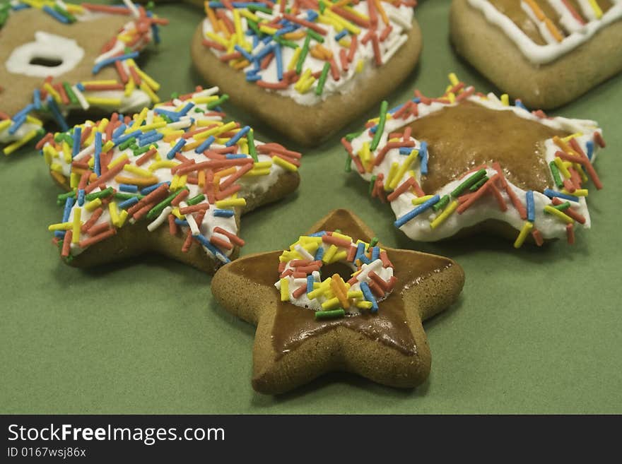 Decorated gingerbread cookies on green paper. Decorated gingerbread cookies on green paper