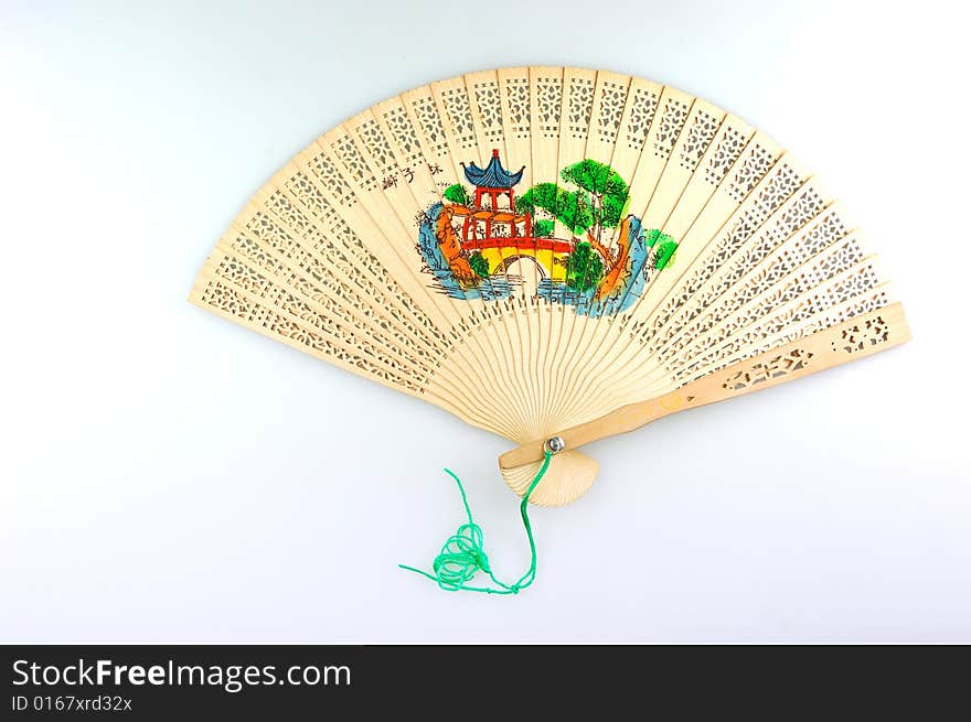 An expanding wooden folding fan on white background