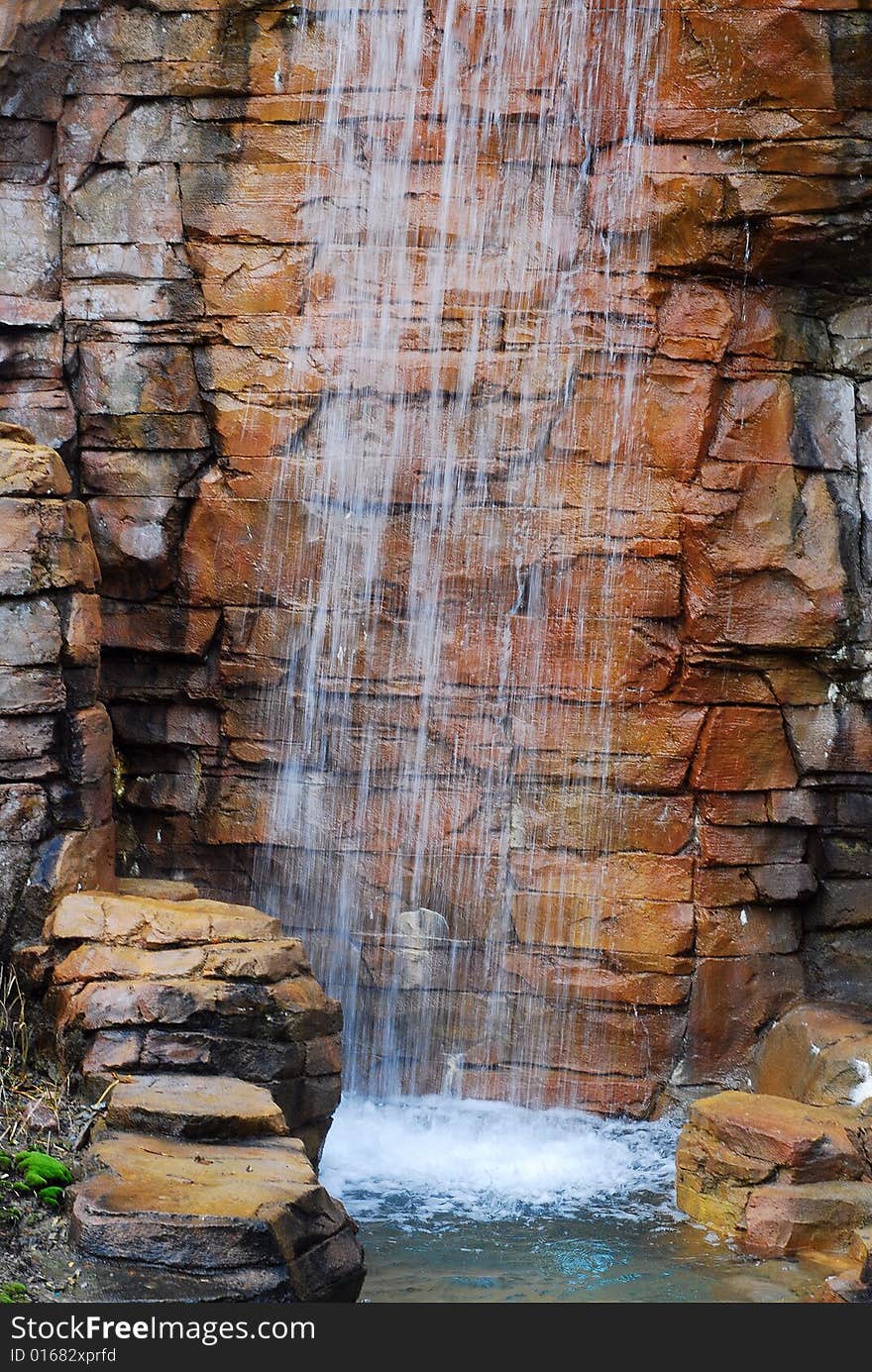 This is a shot of a man made waterfall at a local water park.