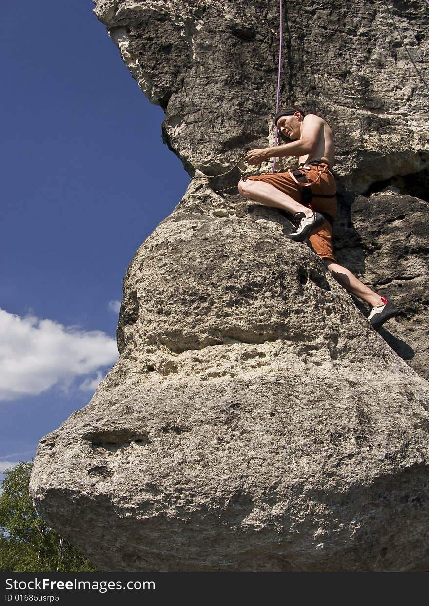 A man climbing at rocks in northern Bohemia, Czech republic