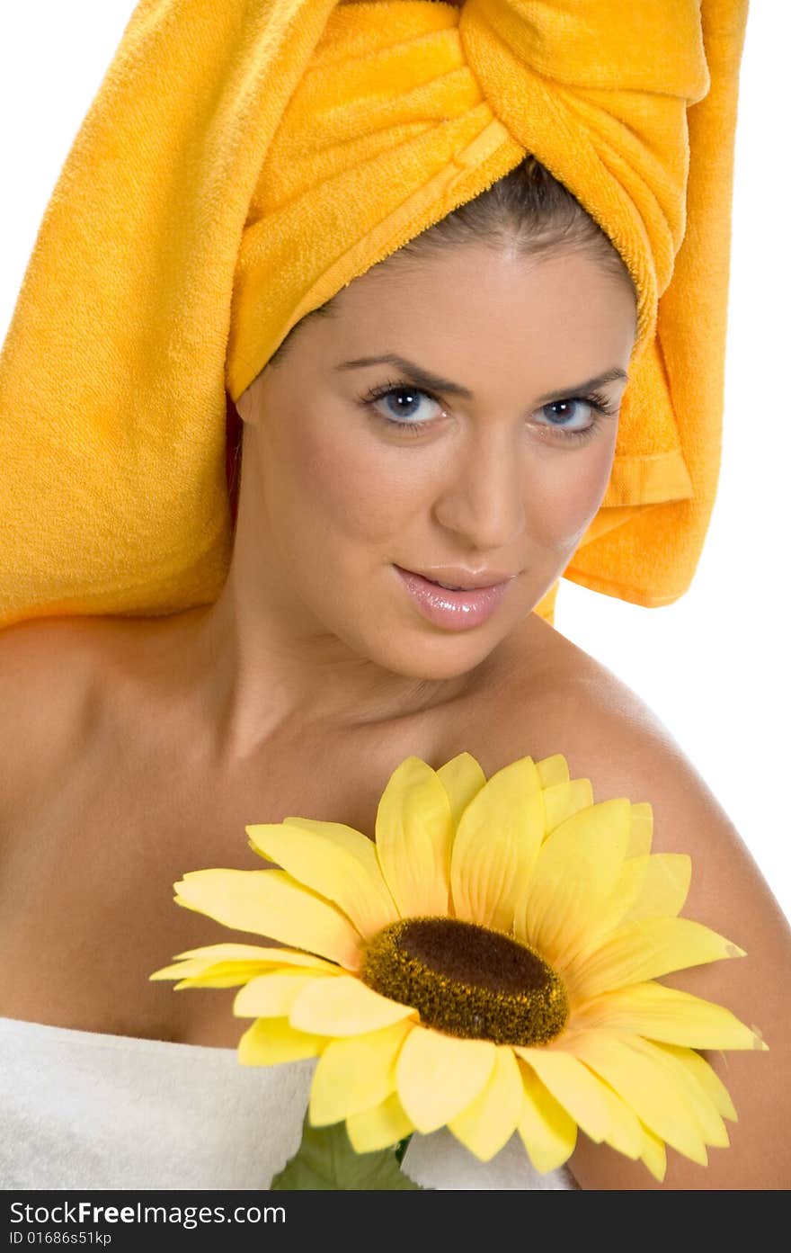 Posing smiling sexy female in towel with sunflower