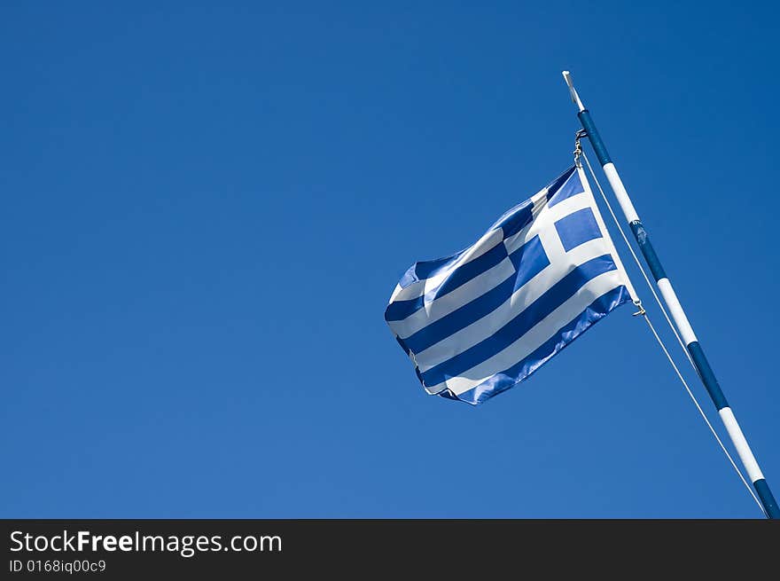 Photo of greece flag over blue sky