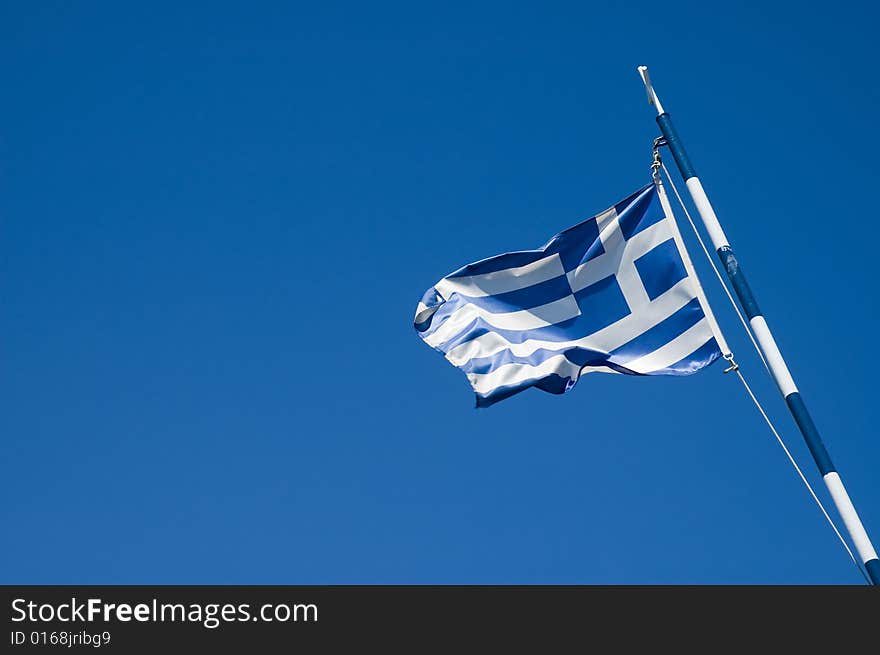 Photo of greece flag over blue sky