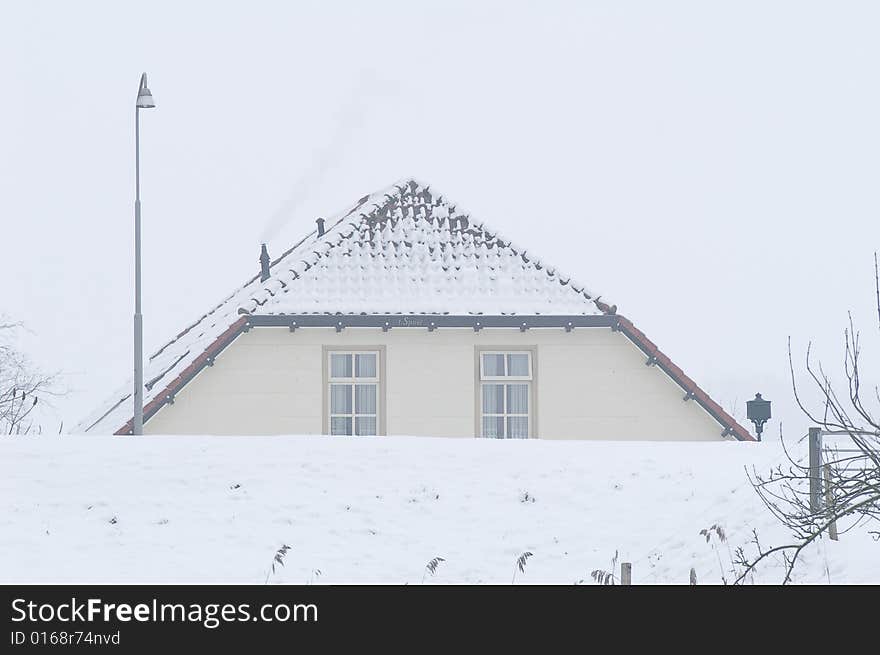 Farm in the foggy snow