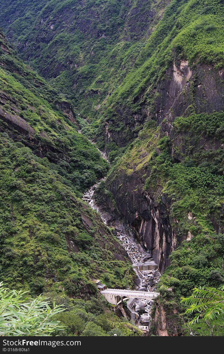 Bridge under lofty and precipitous peaks